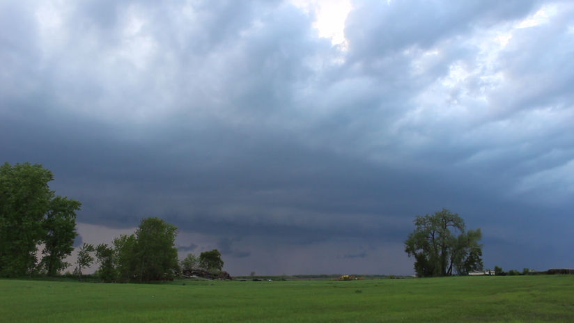 Stormy Skies Over Trees and Sheds